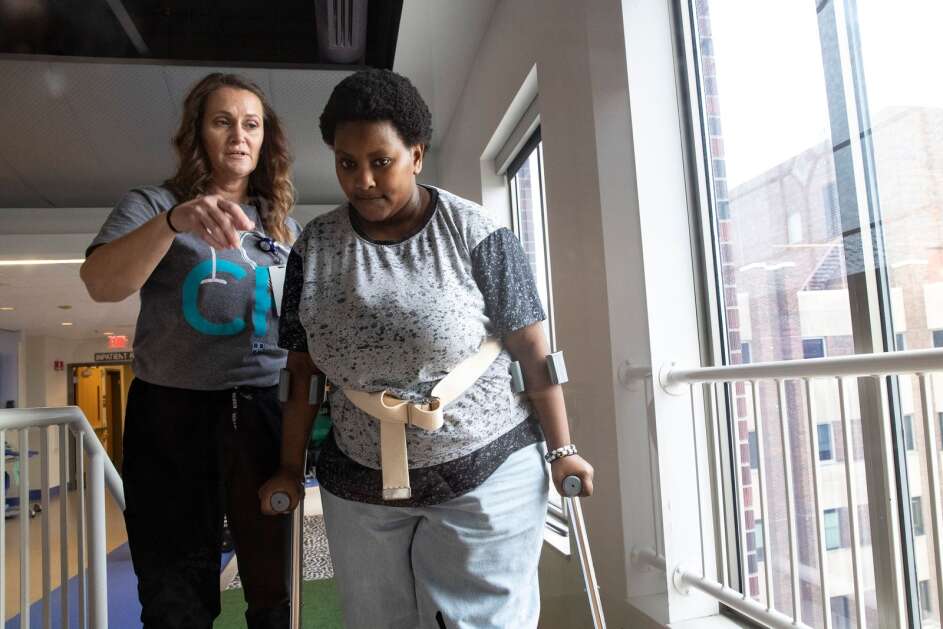 Nakiza Nyankundwa, a senior at Jefferson High School in Cedar Rapids, works May 5 with her therapist, Jen Janatscheck, to complete her exercises at UnityPoint Health-St. Luke’s Hospital in Cedar Rapids. Nyankundwa and her brother were out walking in 2020 and here struck by a drunken driver, losing her leg. Now she is focused on the future and, thanks to a prosthesis, and has her sights set on walking across the graduation stage without help. (Geoff Stellfox/The Gazette)