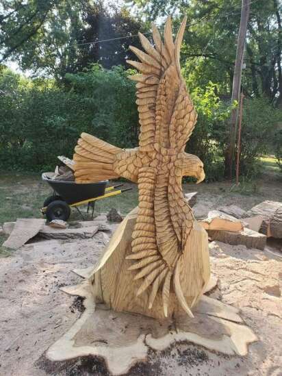 People turn tree debris and stumps from derecho into art