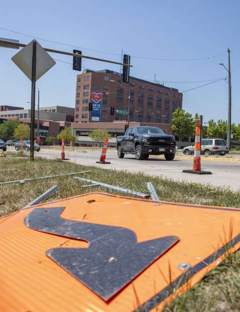 A construction sign lies alongside the road Wednesday as a truck turns onto Mount Vernon Road from 10th Avenue SE in Cedar Rapids. (Savannah Blake/The Gazette)