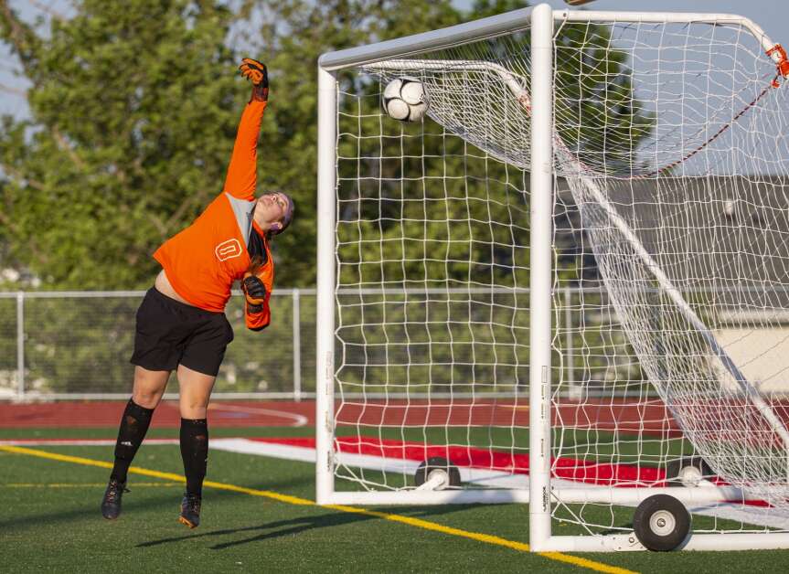 Iowa City Liberty goalkeeper Dani Petersen (0) reaches up to block the shot from Marion, but misses giving Marion a point in the first half of the game at Marion High School in Marion, Iowa on Thursday, May 25, 2023. (Savannah Blake/The Gazette)