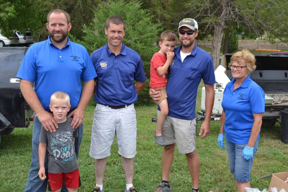Members of the Jefferson County Cattlemen who cooked Saturday’s meal include, from left, Adam Ledger, Max Ledger (in front), Justin Engwall, Brandon Ledger with Owen Ledger, and Zoe Moritz. (Andy Hallman/The Union)