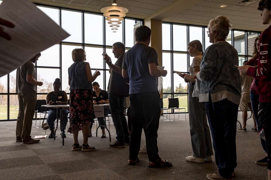 Community members wait in line during a poverty simulation hosted by the Catherine McAuley Center at St. Mark’s Lutheran Church in Marion on Saturday, April 15, 2023. (Nick Rohlman/The Gazette)