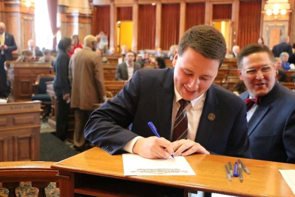 State Rep. Taylor Collins R-Mediapolis, signs the oath of office Jan. 9 in the Iowa House Chamber. (Photo submitted)