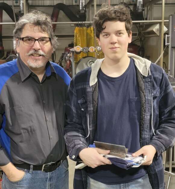Industrial Technology teacher Robbie Kinney (left) stops for a photo with third place welding winner Jack Keagle at the SCC Iowa Southeast Skills Throwdown, Friday. (Photo Submitted)