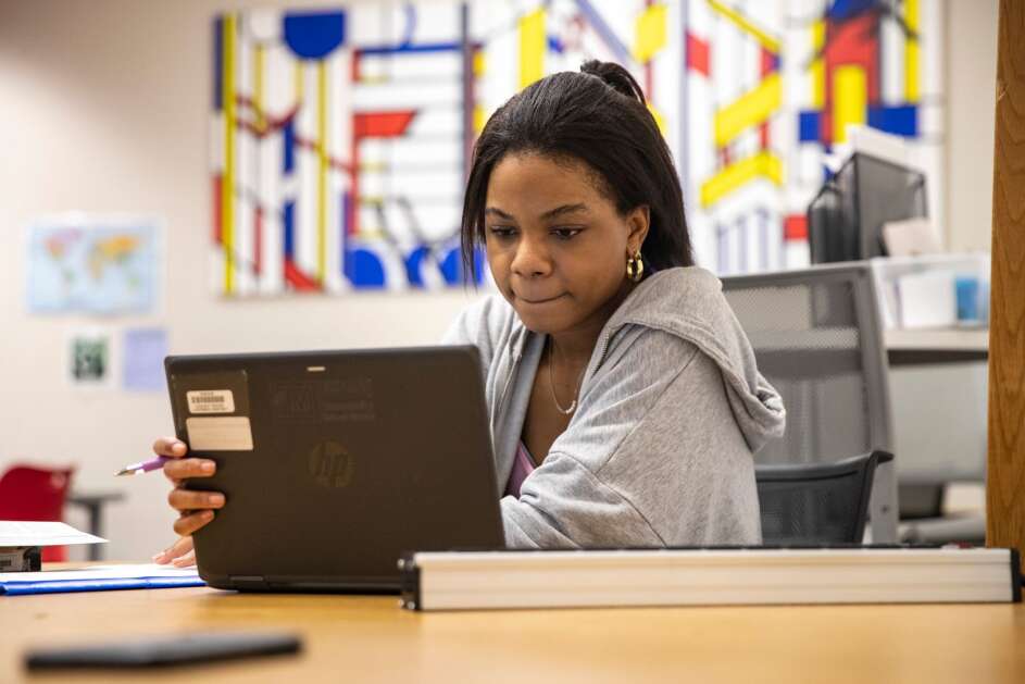 Chrishelle Lawson, a senior at Linn-Mar High School, studies as she waits May 8 for students to tutor at the Marion school. Lawson tutors her fellow students in language arts in her down time, and wants to work for the FBI  to help identify murder victims by their bodies and bones. (Geoff Stellfox/The Gazette)