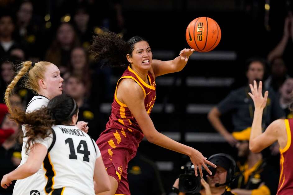 Iowa State center Stephanie Soares, center, passes to a teammate during the second half of an NCAA college basketball game against Iowa, Wednesday, Dec. 7, 2022, in Iowa City, Iowa. Iowa won 70-57. (AP Photo/Charlie Neibergall)
