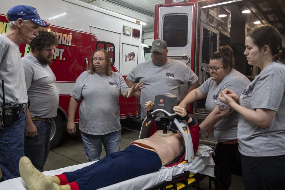 FILE -- EMT Director Kim Krutzfeld (third from left) instructs volunteer EMTs and drivers in using rescue equipment during a training session at the Oxford Junction Volunteer Fire Department. Iowa will spend $150,000 to pilot a program aimed at decreasing emergency response times in rural areas. (Nick Rohlman/The Gazette)