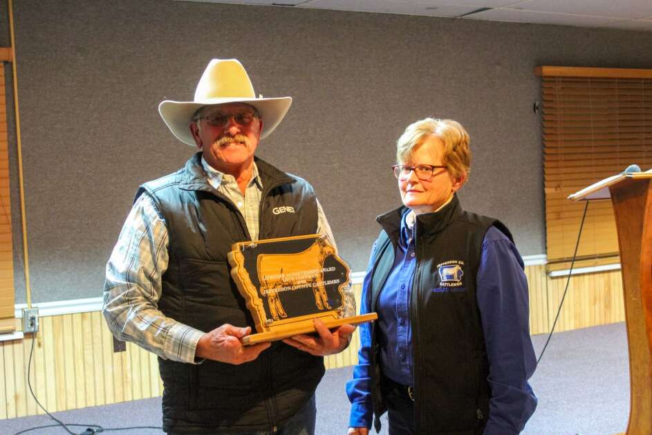 Rick Coffman receives the Lifetime Achievement Award from Jefferson County Cattlemen President Zoe Moritz during the cattlemen’s annual banquet on Jan. 26, 2023. (Photo courtesy of Zoe Moritz)