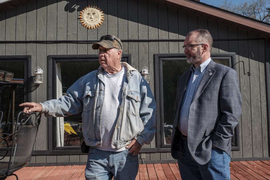 Camanche City Administrator Andrew Kida (right) talks with a resident April 26 in Comanche. (Nick Rohlman/The Gazette)