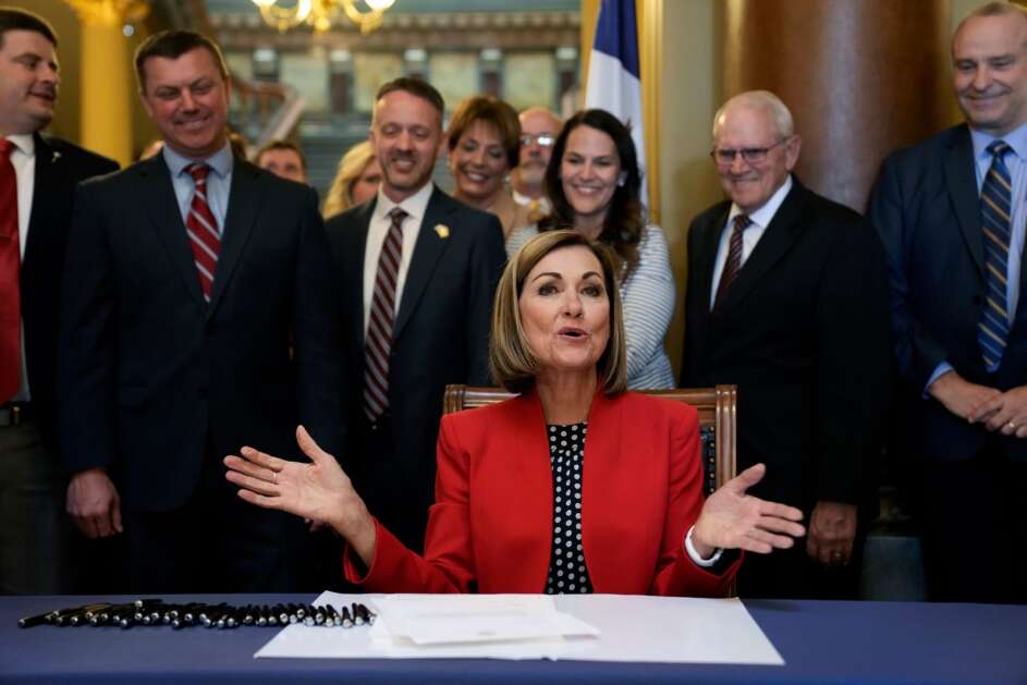 Iowa Gov. Kim Reynolds reacts after signing a property tax cut bill, Thursday, May 4, 2023, at the Statehouse in Des Moines, Iowa. (AP Photo/Charlie Neibergall)