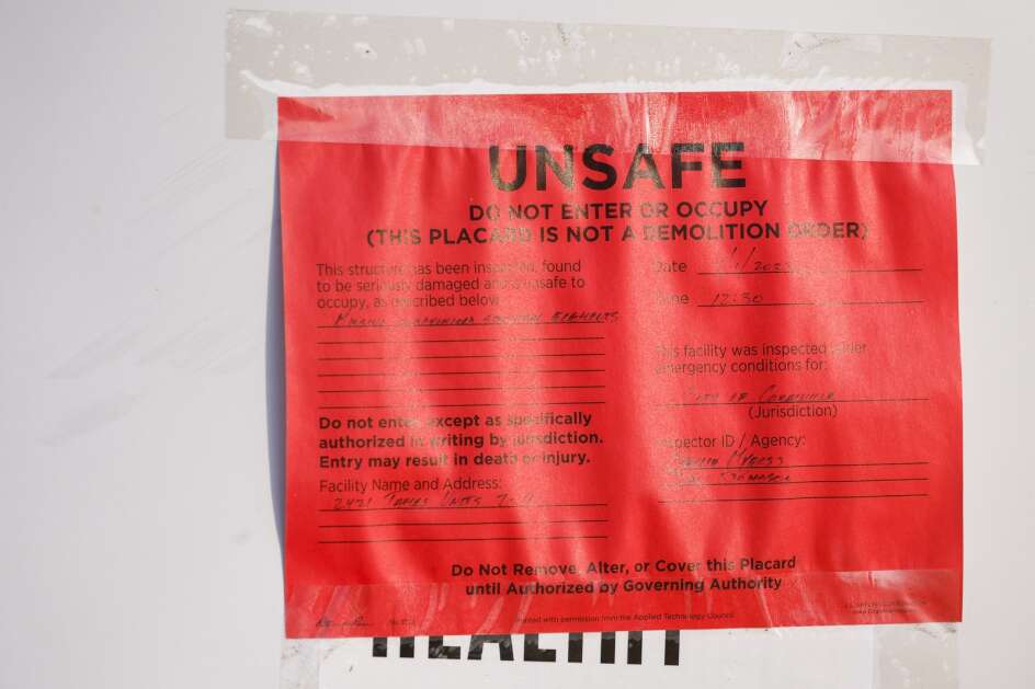 A warning placard is seen at the University of Iowa's College of Engineering's James Street Laboratory in Coralville, Iowa, on Friday, April 14, 2023. The laboratory was destroyed by a tornado March 31. The facility housed a river model used in its hydroscience research.  (Jim Slosiarek/The Gazette)