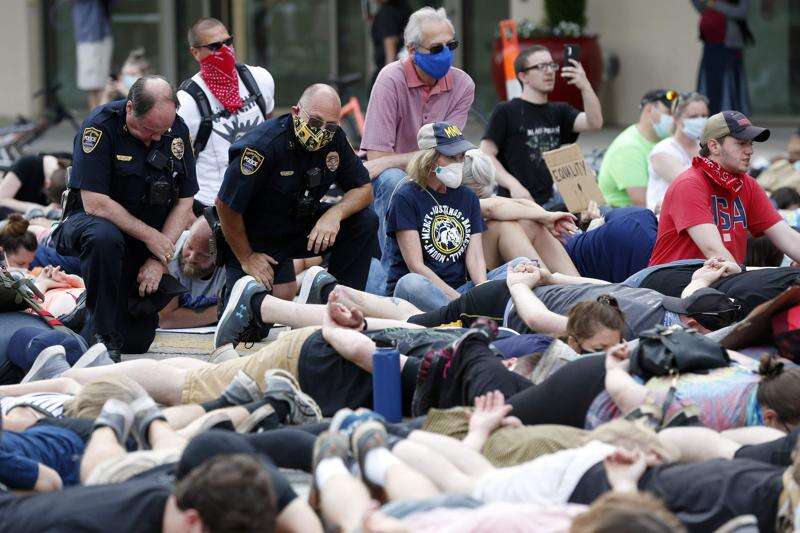 Cedar Rapids Police Chief Wayne Jerman (top left) kneels in the street among protesters as they lay in the street for 8 minutes and 46 seconds on First Avenue in Cedar Rapids on Saturday, June 6, 2020 after the Minneapolis man George Floyd was killed by Minneapolis police. (The Gazette)