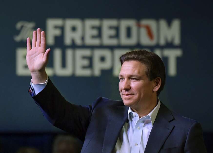 Florida Gov. Ron DeSantis waves to the crowd March 10 as he attends an event in Davenport. (AP Photo/Ron Johnson