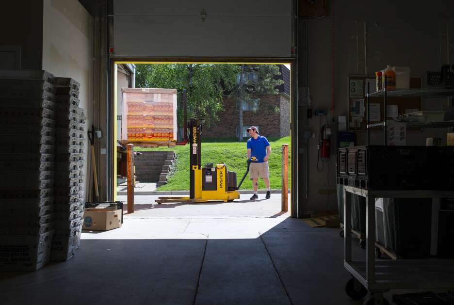 Warehouse coordinator Matt Kimschoot unloads a pallet of cereal off a truck May 16 at the CommUnity Food Bank in Iowa City. The food bank gets deliveries twice a week, and the volume in each delivery varies. (Savannah Blake/The Gazette)