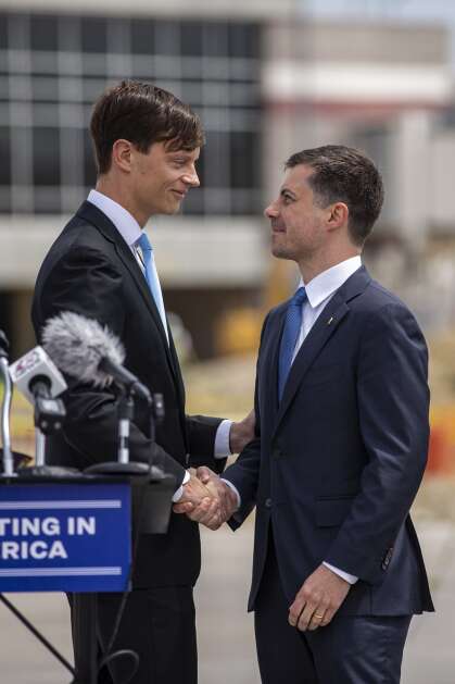Iowa State Auditor Rob Sand (left) shakes hands with U.S. Secretary of Transportation Pete Buttigieg on Thursday event at The Eastern Iowa Airport in Cedar Rapids, Iowa on Sunday, Thursday, May 25, 2023. The airport received a $20. (Nick Rohlman/The Gazette)