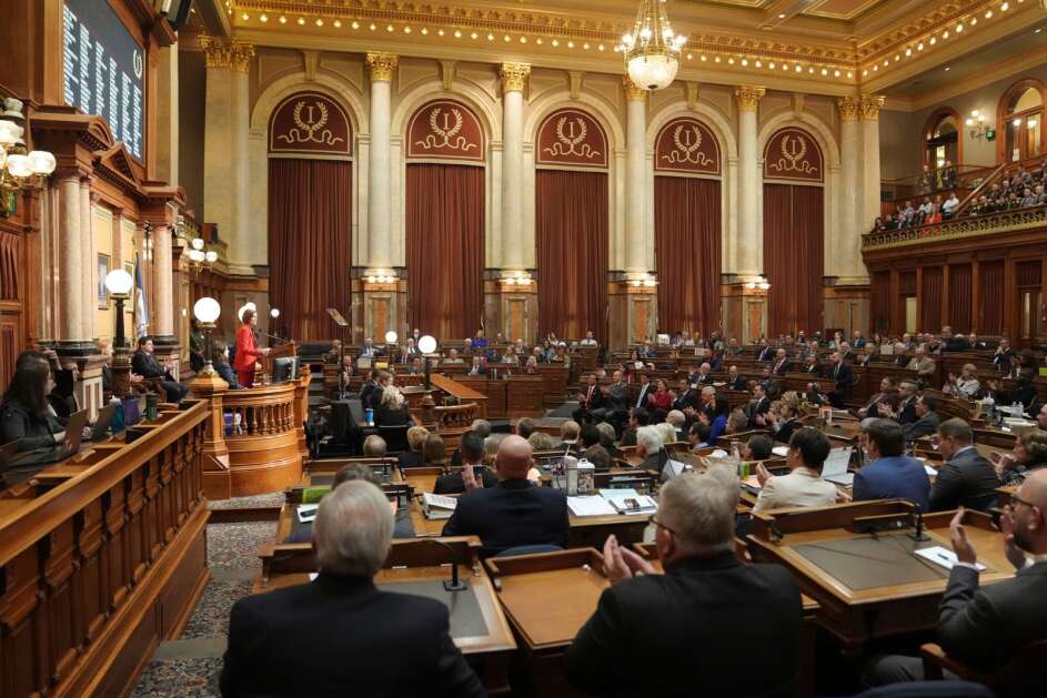 Gov. Kim Reynolds, standing left, gives the annual Condition of the State address Jan. 9 at the Iowa Capitol in Des Moines. Under a bill in the Legislature, the governor’s pay would increase by $10,000 to $140,000 a year. Other statewide elected officials would get $10,000 raises as well. (Zach Boyden-Holmes/Des Moines Register via AP)