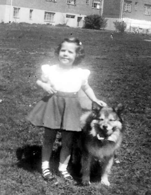 Dianne Martin with their family dog, Puddles, in Baltimore, Md., before moving with her parents, Fred and Betty Coste, to Iowa. Fred Coste was killed Oct. 15, 1979 while working the Family Finance Corporation in downtown Cedar Rapids. (Photo submitted by Dianne Martin)