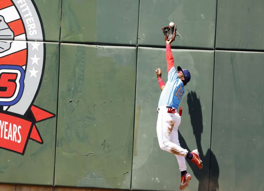 Cedar Rapids Kernels' Misael Urbina makes a leaping catch against the left field wall during their Midwest League baseball game against the Peoria Chiefs at Veterans Memorial Stadium in southwest Cedar Rapids, Iowa, on Sunday, May 21, 2023. (Jim Slosiarek/The Gazette)