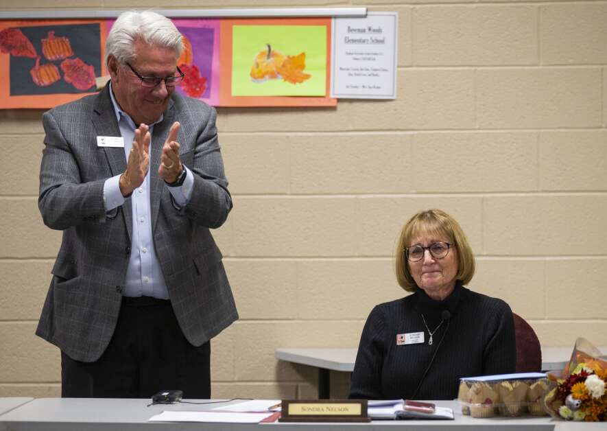 Linn-Mar school board member Sondra Nelson shows emotion as her fellow board member, Barry Buchholz and the rest of the room give her a standing applause after her goodbye speech at the Linn-Mar Community School District building in Marion, Iowa on Monday, Nov. 20, 2023. (Savannah Blake/The Gazette)