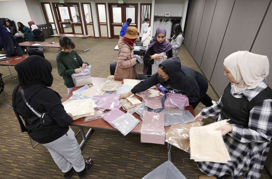 Members of the Mariam Girls’ Club sort hijabs by color as they prepare for an upcoming annual World Hijab Day event at the Coralville Public Library on Saturday, January 27, 2024. The club is partnering for the second year with the library to host a public World Hijab Day event on Thursday, February 1 at 4:30pm where participants can learn about the hijab and women in Islam. The event offers the opportunity to chat with Muslims along with snacks, games, educational material on women in Islam and females in attendance will be able to try on and keep a hijab. (Cliff Jette/Freelance)