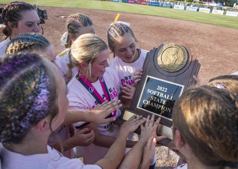Glittery hair, and another shiny trophy for Iowa City Regina softball