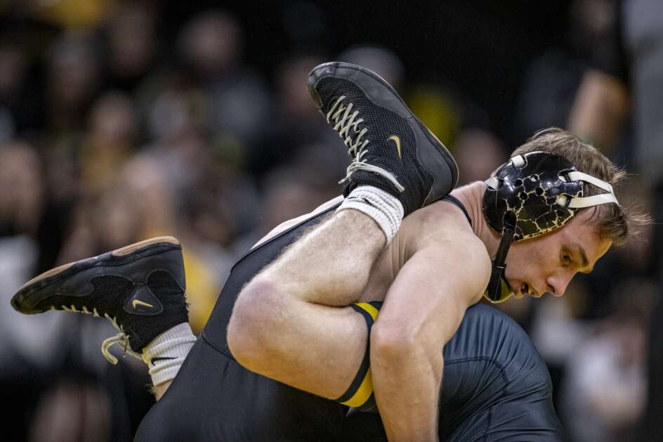Iowa’s Spencer Lee wrestles Michigan’s Jack Medley at 125 pounds during a wrestling dual meet between Iowa and Michigan at Carver-Hawkeye Arena in Iowa City on Friday, February 10, 2023. (Nick Rohlman/The Gazette)