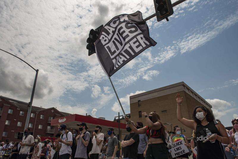 Protesters gather at the intersection of Gilbert and Burlington streets during a Juneteenth Celebration in Iowa City on Saturday, June 20, 2020. The event capped more than two weeks of protests for racial justice in Iowa City. (Nick Rohlman/freelance)