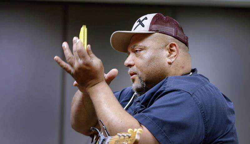 Blues musician Kevin ‘B.F.’ Burt teaches harmonica skills at Coralville Public Library workshop