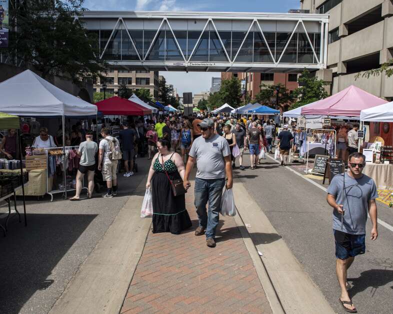 Market goers walk on Third Street at the Cedar Rapids Farmers’ Market in Cedar Rapids, Iowa on Saturday, July 2, 2022. (Nick Rohlman/The Gazette)