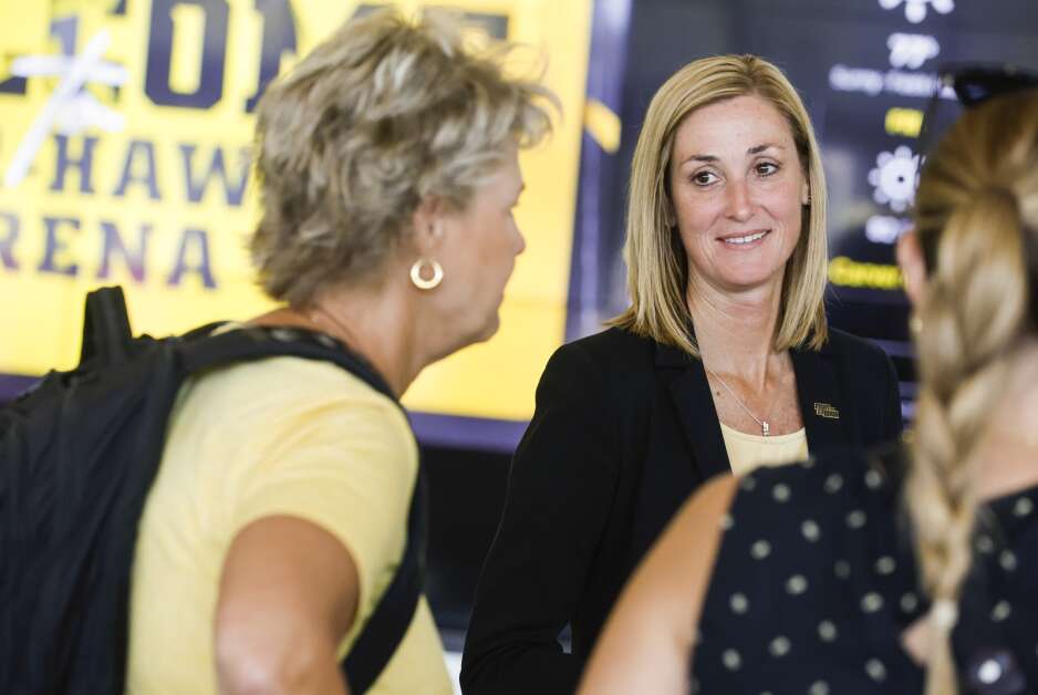 University of Iowa interim athletics director Beth Goetz (right) speaks Aug. 17 with women's basketball coach Lisa Bluder (left) after a news conference at Carver-Hawkeye Arena in Iowa City.  (Jim Slusiarek/The Journal)