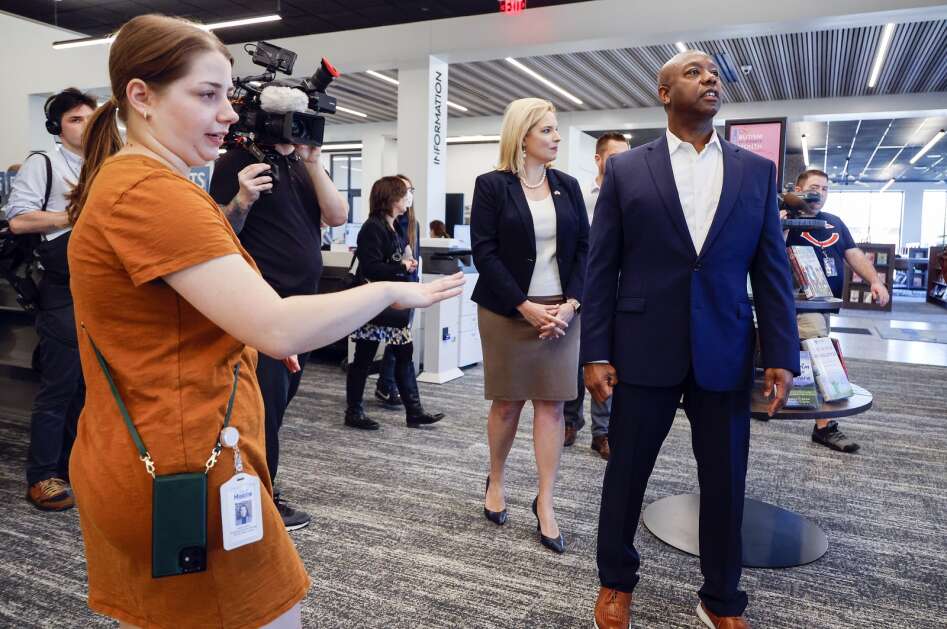 Ashley Osborn (left) marketing and special events manager at the Marion Public Library leads South Carolina Republican U.S. Sen. Tim Scott (right) and Iowa Republican U.S Rep. Ashley Hinson (center) on a tour of the recently opened library in Marion, Iowa, on Wednesday, April 12, 2023. Scott made multiple stops in Iowa as part of his Faith in America Tour as he makes preparations for a 2024 presidential run. (Jim Slosiarek/The Gazette)