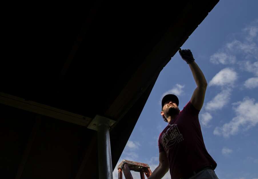 Jason Sweet of Hibu paints the outside of the pavilion while volunteering for Day of Caring at Van Vechten Park in Cedar Rapids, Iowa on Thursday, May 11, 2023. (Savannah Blake/The Gazette)
