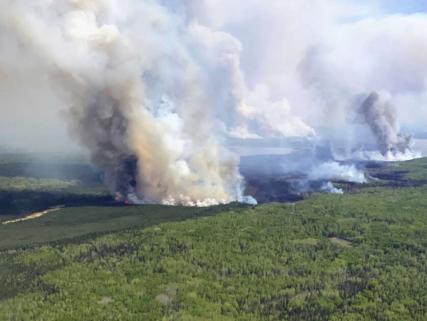 In this photo provided by the Government of Alberta, Canada, the Eagle Wildfire burns, Saturday, May 13, 2023. Wildfire officials in Alberta say hot, dry and windy weather has pushed fire conditions even further into the extreme in the province's north this weekend, and the situation in the south is now a growing concern. (Government of Alberta Fire Service/The Canadian Press via AP)