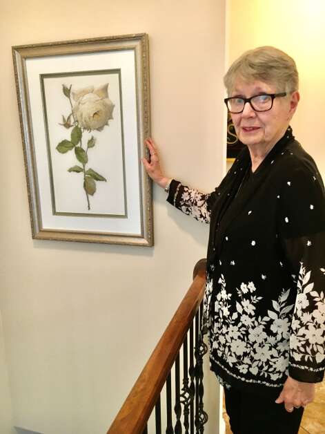 Sheri Ekstrom of Cedar Rapids, a longtime member of the Cedar Valley Chapter of the Embroiderers' Guild of America, stitched this portrait of the Diana Rose, named after the late Princess Diana. The piece hangs in the stairwell of Ekstrom's home. (Diana Nollen/The Gazette)