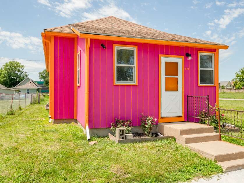 The "Pretty in Pink" house is seen on Tuesday, July 13, 2022. This house is the first on a block of M Street SW between 10th and 12th Avenues SW that Gutschmidt Properties is transforming into "Rainbow Road." Ten houses will be painted the colors of the rainbow as a symbol of LGBTQ inclusion. (Photos by Ben Kaplan/Gutschmidt Properties)