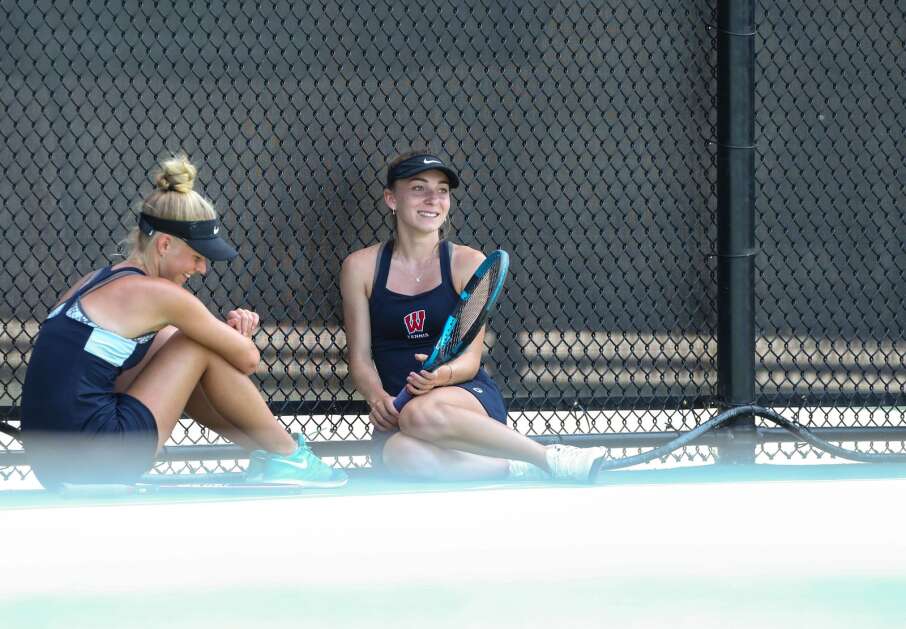 Cedar Rapids Washington’s Kathryn Zylstra (right) smiles while taking a break with Katelynn Kock during the Class 2A doubles third place match of the Iowa Girls High School State Tennis Tournament at the Hawkeye Recreation & Tennis Complex in Iowa City on Thursday, June 3, 2021. (Andy Abeyta/The Gazette) 