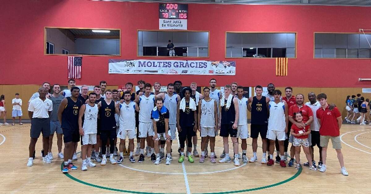 The Iowa men’s basketball team and its Spanish opponents after a game in Barcelona (Iowa Basketball X feed)