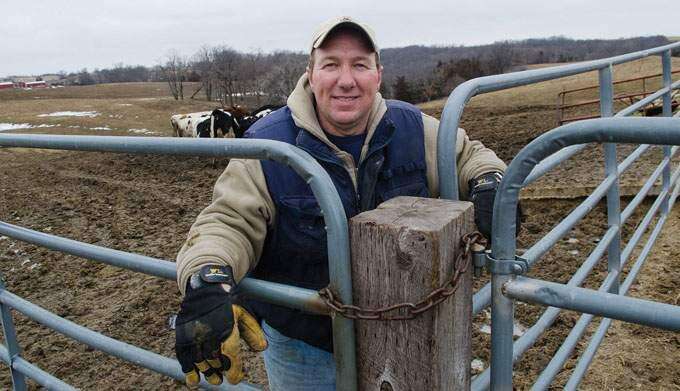 Joe Heinrich, 51, a dairy farmer near Maquoketa, is paying close attention to the goings-on in Washington, D.C., these days. If Congress fails to adopt a new farm bill, policies take effect at midnight Monday, Dec. 31, 2012, that would push milk prices to $6 or $8 a gallon. (Iowa Farm Bureau photo)
