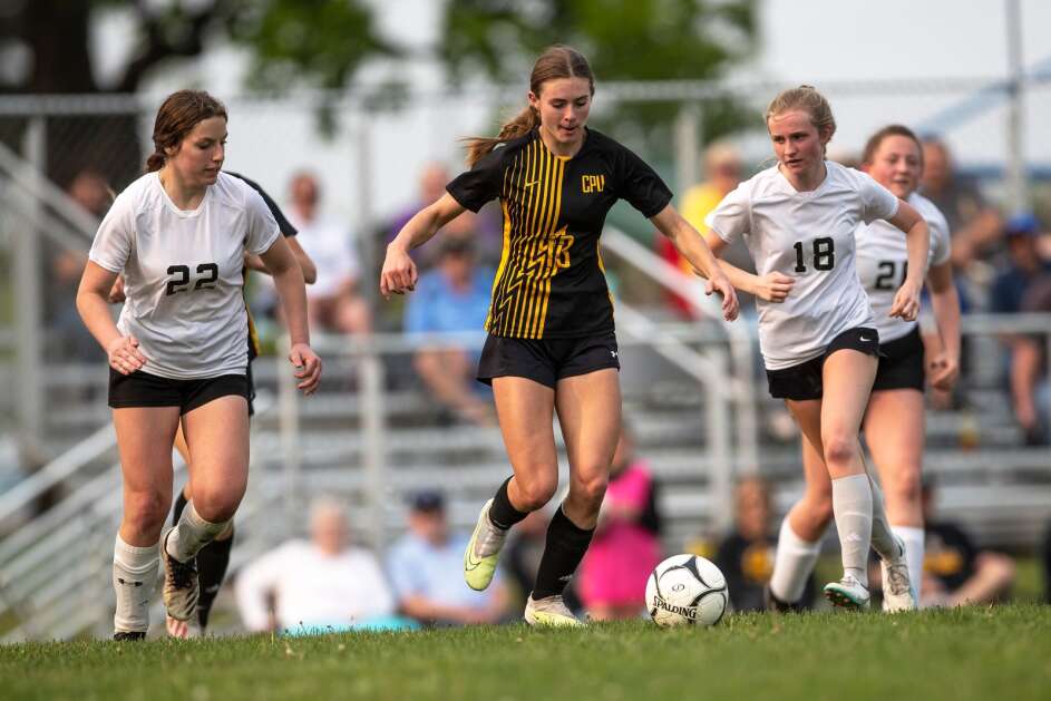 CPU’s Emily Bowe (13) splits two defenders during a class 1A regional girls soccer game between Center Point-Urbana and Cedar Valley Christian on Wednesday, May 17, 2023, at Fross Park in Center Point, Iowa. (Geoff Stellfox/The Gazette)