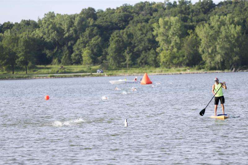 Paddlers keep watch over swimmers July 26, 2020, at the Pigman Triathlon at Pleasant Creek State Recreation Area near Palo. Pleasant Creek tested within safe standards for swimming every week this summer. (The Gazette)