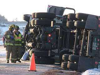 Driver pulled from cab after truck overturns on Interstate 380