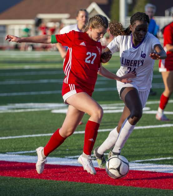 Iowa City Liberty midfielder Eno Ituk (24) guards Marion forward Hayley Potter (27) as she drives the ball down the field in the first half of the game at Marion High School in Marion, Iowa on Thursday, May 25, 2023. (Savannah Blake/The Gazette)
