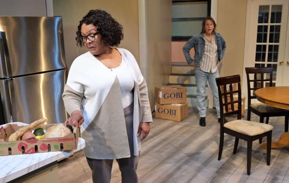One of the first surprises for Sharon (Joy Vandervort-Cobb, left) is that her new roommate, Robyn (Mary Mayo), is vegan, and has brought with her a box of vegetables Sharon has never heard of. More differences unfold between empty nester Sharon and mysterious Robyn in "The Roommate," onstage through May 14 at Riverside Theatre in Iowa City. (Rob Merritt)
