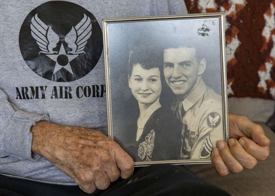 World War II veteran Mike Bisek holds a portrait of him and his wife during their engagement when he was still in the service at his house in Cedar Rapids, Iowa on Monday, April 10, 2023. The couple met while Bisek was stationed in Mississippi and they were married in his final year of service when he was 22 years old. (Savannah Blake/The Gazette)