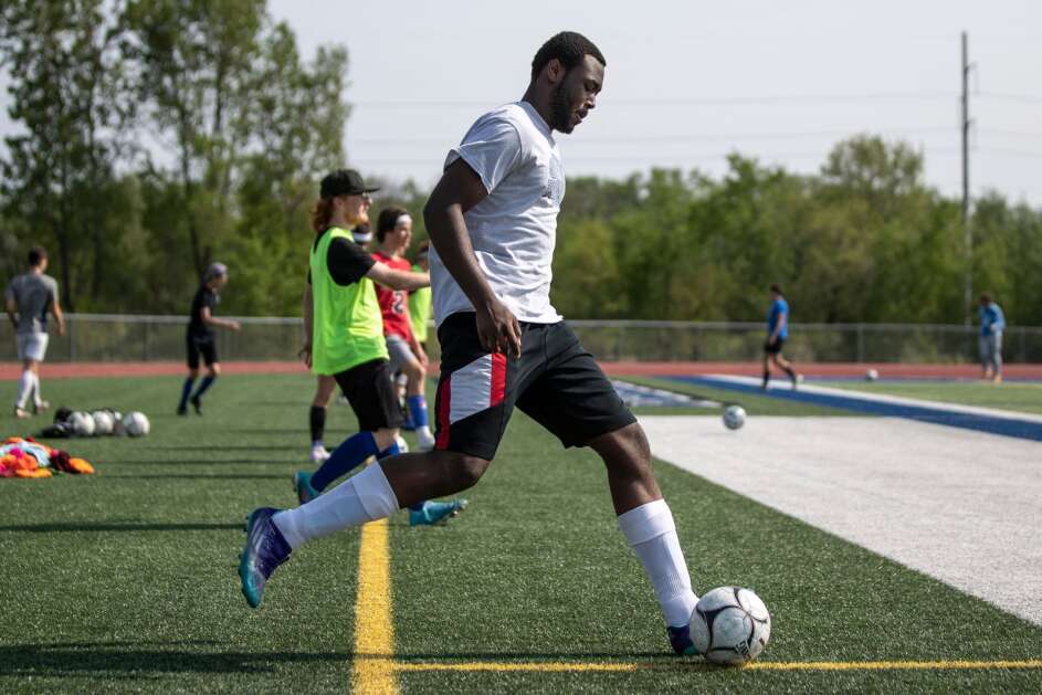 Clear Creek Amana High School senior Ahmed Kunate plays a pass to a teammate during soccer practice May 19, 2023 at the school in Tiffin. He plans to attend Kirkwood Community College this fall. (Geoff Stellfox/The Gazette)