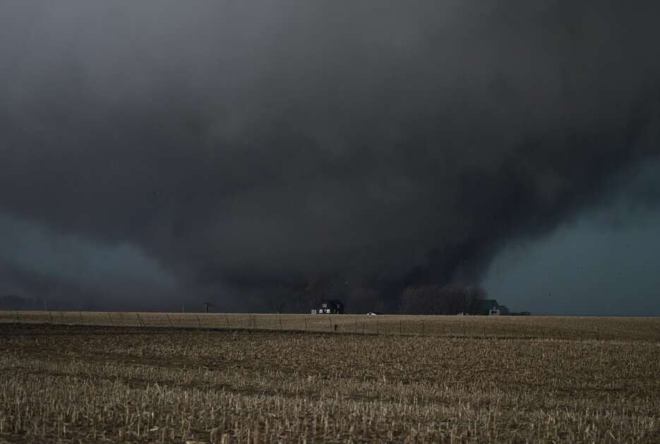 A large tornado carves a path through a cornfield northeast of Keota  on March 31. The  EF4 funnel tracked into Wellman in Washington County before dissipating in southwest Johnson County. (Bryon Houlgrave/Freelance)