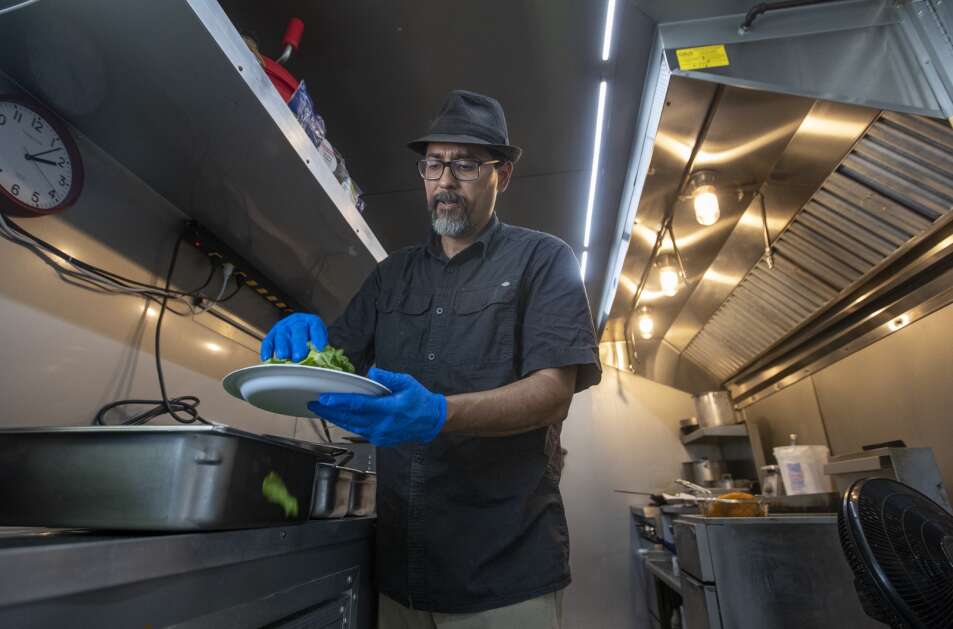 Chef Daniel Velasquez prepares a veggie fry bread at South Side Street Foods food truck in Iowa City in June 2022. Soon, food trucks in Iowa City will be congregating at the South District Market for a new event. (Savannah Blake/The Gazette)