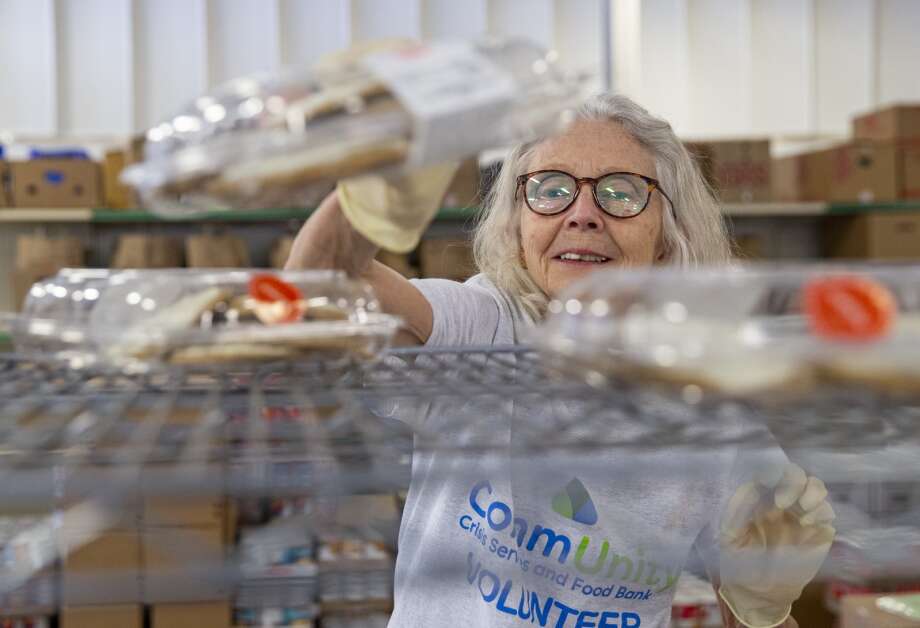 Volunteer Barbara Roark stocks the shelves May 16 with baked good items at the CommUnity Food Bank in Iowa City. Roark has been volunteering at the food bank for over 20 years. (Savannah Blake/The Gazette)