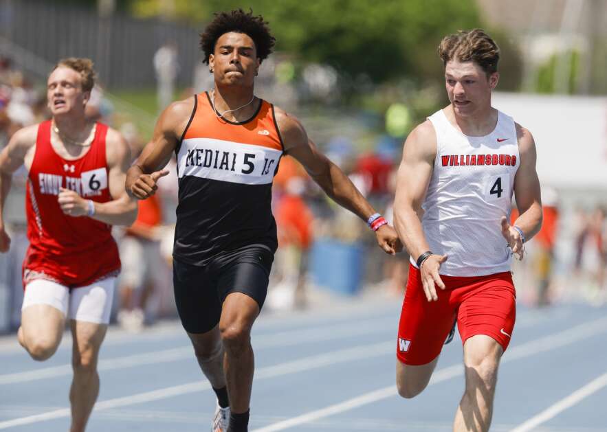 Williamsburg's Owen Douglas (right) gets nudged by Mediapolis' Anthony Isley in the final meters of the Class 2A boys’ state track and field 200-meter dash Saturday at Drake Stadium in Des Moines. (Jim Slosiarek/The Gazette)