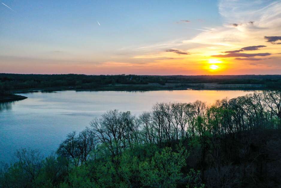 The Iowa River is seen flowing into Coralville Lake as the sun sets in Solon in April 2021. (The Gazette)